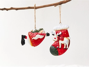 Detailed view of metal painted Santa and reindeer stocking ornaments on a branch