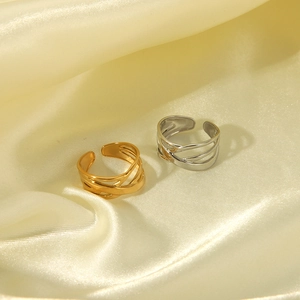 Detail of layered titanium steel rings in gold and silver on soft satin fabric