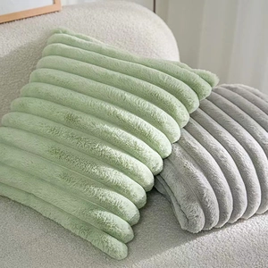 Detail view of soft striped faux fur plush pillows in light green and gray colors