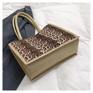 Detailed macro view of the leopard print pattern and jute texture on this tote bag