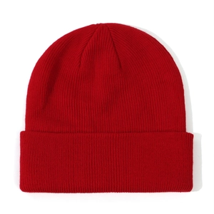 Detailed close-up showing the bright red ribbed knit texture of a baby beanie hat