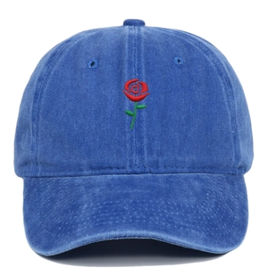 Detail of red rose embroidery on vintage washed navy blue cotton baseball cap