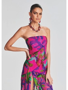 Detail of floral tube dress featuring pink, purple and green mesh fabric and red necklace