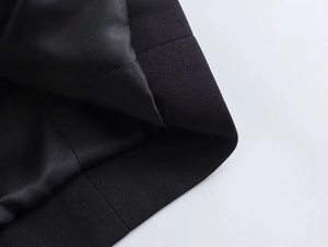 Macro detail of high-quality black twill fabric and smooth silk lining on casual blazer