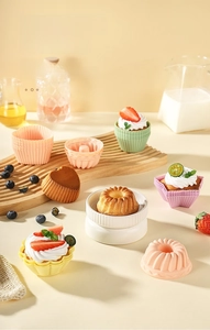 Detail of colorful food-grade silicone muffin cups and heart-shaped cake molds on a tray