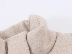Close-up of soft oatmeal beige wool fabric texture with high-quality stitching details