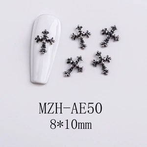 Detailed view of silver gothic cross nail charms with dimensions and application example
