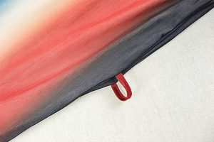 Macro detail of breathable gradient mesh fabric showing fine texture and elastic loop
