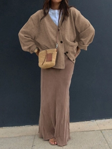 Detail view of a brown V-neck knit cardigan with matching straight long skirt