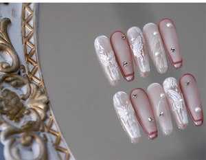 Detail view of 5D butterfly matte press-on nails with pearls and rhinestones