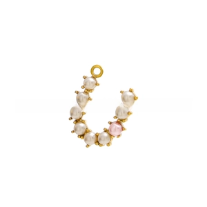 Macro view of horseshoe-shaped gold pendant with inlaid white and pink pearls