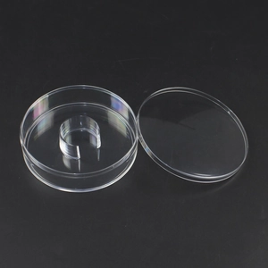 Clear round bracelet display box with internal ring holder on elegant black background
