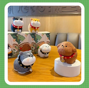 Detailed texture of cute resin dog figurines with collars on a wooden table