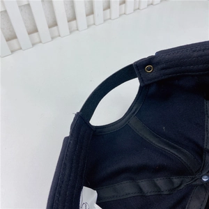Detailed macro view of the navy docker hat interior with adjustable strap and metal grommet