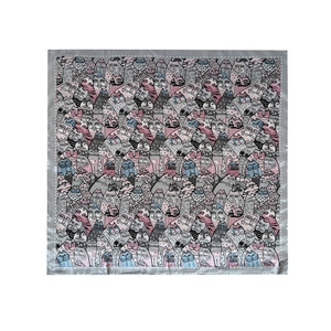 Detail shot of square silk scarf featuring colorful cartoon cat patterns on white background