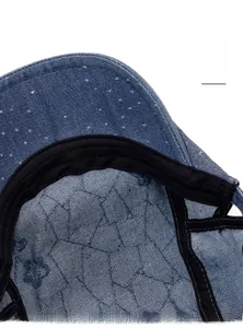 Close-up of the soft black inner sweatband and denim fabric texture on a newsboy cap