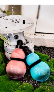 Detailed view of creative gourd-shaped water bottles in pink and blue colors