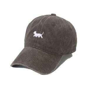 Close-up of dog embroidery and washed vintage cotton texture on baseball cap