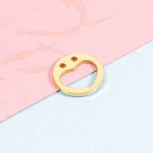 Detailed macro view of 12mm golden stainless steel heart cutout charm with dual connector holes