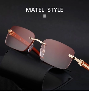 Detailed close-up of rimless sunglasses with pink-brown gradient lenses and wood grain temples