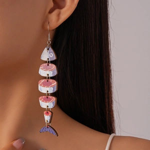 Detail of fish-shaped wooden print drop earrings with multi-segment design on model