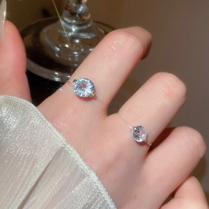 Close-up of minimalist clear string ring with round cut cubic zirconia in four-prong setting