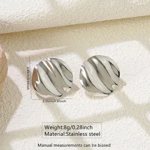 Detailed view of silver stainless steel earrings with wavy texture and dimensions
