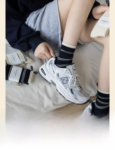 Close-up of navy blue striped cotton socks paired with retro white sneakers in daily life