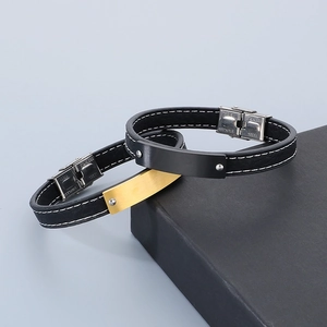 Detailed shot of black and gold stainless steel plates on premium leather bracelets