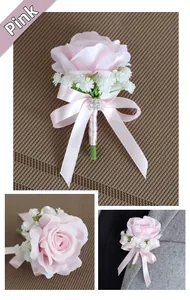 Pink artificial rose boutonniere with satin ribbon and rhinestone detail on grey suit