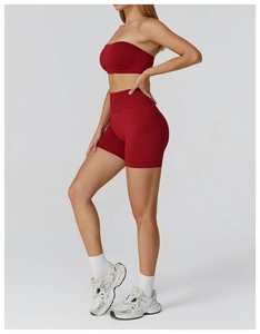 Detail view of seamless deep red yoga set featuring high-waist shorts and sports crop top