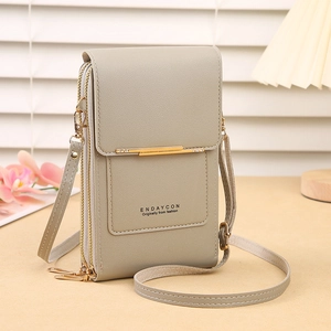 Detail view of grey touch screen phone crossbody bag with double zippers and gold metal trim