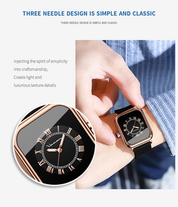 Detail of rose gold square watch case with Roman numerals and black silicone strap