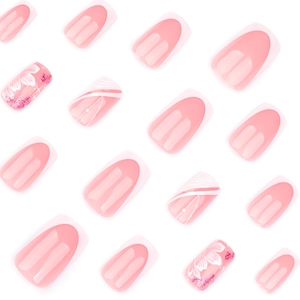 Pink and white French style press-on nails with floral patterns and pink glitter