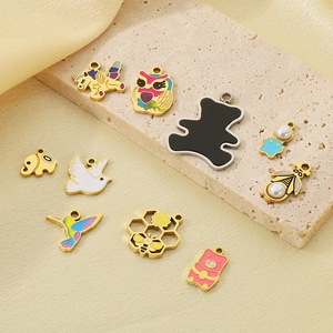 Detailed view of colorful enamel animal charms with gold accents and pearl inlay details