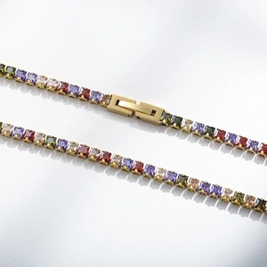 Macro shot of 18K gold plated chain with multi-color square gemstones and secure foldover clasp