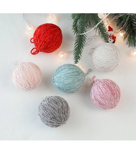 Detailed view of colorful wool felt Christmas tree balls on a cozy festive background