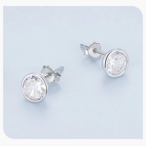 Macro shot of sparkling zircon stone inlay on S925 sterling silver stud earrings pair