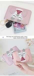 Detail of cute cat and owl coin purses with zipper and metal keychain for cards and coins