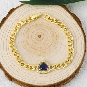 Gold-plated Cuban chain bracelet with a heart-shaped blue gemstone and sparkling zircons
