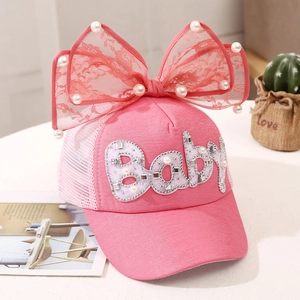 Detailed view of pink mesh sun hat featuring lace bow, pearls and Baby rhinestone letters