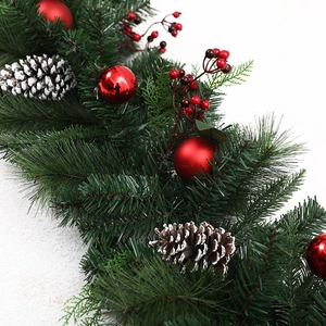 Christmas wreath garland with red berries and snowy pine cones on white background