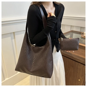 Detailed close-up of dark brown woven leather hobo bag with matching zip pouch