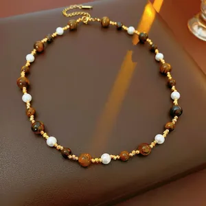 Vintage style tiger eye and pearl necklace with golden spiral spacers on leather