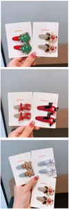 Detailed view of handmade Christmas hair clips set with reindeer and tree embroidery