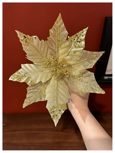 Close-up of golden glitter Christmas flower decoration with multi-layered fabric petals
