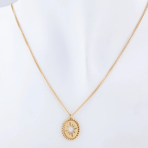 Detail of gold oval pendant with hollow star design on a white minimalist mannequin