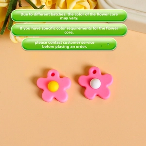 Detail of pink resin flower pendants with colorful centers for DIY jewelry making