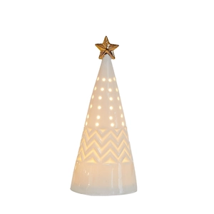 Illuminated white ceramic Christmas tree with golden star and warm glowing cutout holes