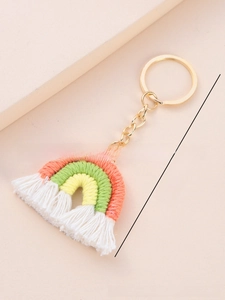 Macro shot of handmade rainbow keychain with colorful cotton ropes and white tassels